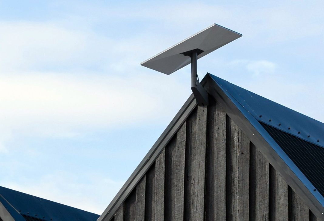 Starlink satellite dish mounted on a roof with clear sky view